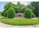 Stone 'Ridge Pointe' entrance sign surrounded by manicured bushes and lush greenery, offering a welcoming feel to the community at 916 Coffee Tree Ln, Rock Hill, SC 29732