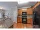 Modern kitchen with black appliances, wood cabinets, and granite countertop at 916 Coffee Tree Ln, Rock Hill, SC 29732