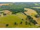 A wide aerial view shows the property's rolling landscape and surrounding nature at 930 Hawley Rd, McConnells, SC 29726