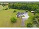 Aerial perspective of the home with lush landscaping, mature trees, and long driveway at 930 Hawley Rd, McConnells, SC 29726