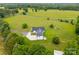 Drone shot of property featuring sprawling green space, mature trees, and ample privacy at 930 Hawley Rd, McConnells, SC 29726