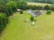 Aerial view of the property showcasing spacious grounds, outbuildings, and mature trees at 930 Hawley Rd, McConnells, SC 29726