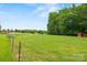Large backyard space with fencing and mature trees, perfect for outdoor activities at 930 Hawley Rd, McConnells, SC 29726