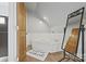 Bathroom featuring a tub, hardwood flooring, and decor mirror at 930 Hawley Rd, McConnells, SC 29726