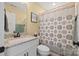 Bathroom featuring a granite countertop vanity, framed mirror, and a shower with decorative patterned curtain at 930 Hawley Rd, McConnells, SC 29726