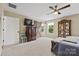 Bedroom featuring a barn door, ceiling fan, dresser, and a display cabinet for collectibles at 930 Hawley Rd, McConnells, SC 29726