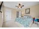Comfortable bedroom with plush carpeting, featuring a ceiling fan, two closets, and ample natural light at 930 Hawley Rd, McConnells, SC 29726