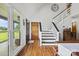 Bright foyer with hardwood floors, staircase, and a view of the outdoors, creating a warm welcome at 930 Hawley Rd, McConnells, SC 29726
