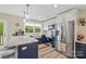 Modern kitchen with stainless steel appliances, white upper cabinets, and a contrasting navy blue island at 930 Hawley Rd, McConnells, SC 29726