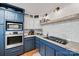 Kitchen boasting stainless steel appliances, custom blue cabinets, and stone countertops at 930 Hawley Rd, McConnells, SC 29726