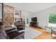 Spacious living room featuring a stone fireplace, high ceilings, hardwood floors, and a plush white rug at 930 Hawley Rd, McConnells, SC 29726