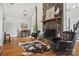 Cozy living room with a stone fireplace, hardwood floors, and comfortable seating, great for gatherings at 930 Hawley Rd, McConnells, SC 29726