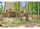 Large backyard with mature trees, a multilevel deck, and lush greenery at 9437 Macquarie Ln, Charlotte, NC 28227