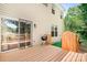 View of the deck off the back of the house with a BBQ grill, siding, and mature trees at 9437 Macquarie Ln, Charlotte, NC 28227