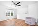 Bedroom with wood floors, ceiling fan, and large window for plenty of natural light at 9437 Macquarie Ln, Charlotte, NC 28227