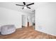 Spacious bedroom features ceiling fan, wood floors, and leads to other rooms at 9437 Macquarie Ln, Charlotte, NC 28227