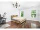 Bedroom with hardwood floors, a rustic wood bed frame, and modern chandelier at 9437 Macquarie Ln, Charlotte, NC 28227
