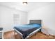 Simple bedroom with wood floors, a bed with grey headboard, and natural light from the window at 9437 Macquarie Ln, Charlotte, NC 28227