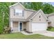 Charming two-story home with a manicured lawn and an attached garage showcasing curb appeal at 9437 Macquarie Ln, Charlotte, NC 28227
