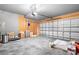 Spacious garage with plywood walls, overhead door and opener, and a concrete floor at 9437 Macquarie Ln, Charlotte, NC 28227