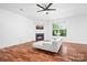 Cozy living room featuring hardwood floors, a fireplace, and plenty of natural light at 9437 Macquarie Ln, Charlotte, NC 28227