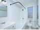 Clean bathroom with a classic white tiled shower/tub combo, vintage hardware and natural light at 101 S Laurel Ave # 72A, Charlotte, NC 28207