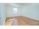 Bright bedroom features hardwood floors, a ceiling fan and a sun-filled window at 101 S Laurel Ave # 72A, Charlotte, NC 28207