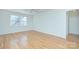 Empty room with hardwood floors, a ceiling fan, and natural light at 101 S Laurel Ave # 72A, Charlotte, NC 28207