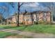 Beautiful brick apartment building with lush green lawn and mature trees at 101 S Laurel Ave # 72A, Charlotte, NC 28207