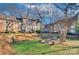 Exterior view of the building with a green backyard and lush trees at 101 S Laurel Ave # 72A, Charlotte, NC 28207