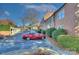 View of the parking lot next to a brick building featuring car park and lush shrubs at 101 S Laurel Ave # 72A, Charlotte, NC 28207