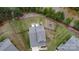 An aerial view showcasing the property's expansive fenced-in backyard and proximity to a serene pond and lush greenery at 10100 Jack Nicklaus Dr, Lancaster, SC 29720