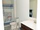 Well-lit bathroom features decorative tile, toilet, sink, mirror and patterned shower curtain at 10100 Jack Nicklaus Dr, Lancaster, SC 29720