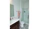 Bathroom with modern patterned tile flooring, white sink vanity, and a glass-enclosed shower at 10100 Jack Nicklaus Dr, Lancaster, SC 29720