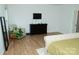 Bedroom with hardwood floors, armchair, dresser, and a door leading to another room at 10100 Jack Nicklaus Dr, Lancaster, SC 29720