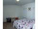 Bedroom with neutral-colored carpet, two windows, a desk, and a bed with purple floral bedding at 10100 Jack Nicklaus Dr, Lancaster, SC 29720