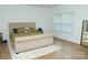 Bright bedroom featuring a large bed with a teddy bear, wood flooring, and natural light from the window at 10100 Jack Nicklaus Dr, Lancaster, SC 29720