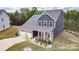 Beautiful home with a two-car garage, stone accents, gray siding, well-maintained lawn, and a cozy front porch at 10100 Jack Nicklaus Dr, Lancaster, SC 29720