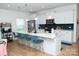 Bright, open kitchen with white cabinetry, a large island with seating, and modern stainless steel appliances at 10100 Jack Nicklaus Dr, Lancaster, SC 29720