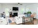 Bright living room featuring hardwood floors, a fireplace with mantel, and a comfortable seating arrangement at 10100 Jack Nicklaus Dr, Lancaster, SC 29720