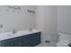 Bathroom featuring double sinks, chrome faucets, and vanity cabinet with blue painted drawers at 1013 Doby Springs Dr, Charlotte, NC 28262