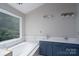 Bathroom with a double sink vanity with white countertops and garden window at 1013 Doby Springs Dr, Charlotte, NC 28262