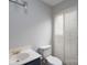 Bathroom with a white toilet, blue vanity, white shutters, and gold fixtures at 1013 Doby Springs Dr, Charlotte, NC 28262