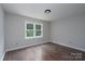 Bright bedroom features hardwood floors and a large window providing natural lighting at 1013 Doby Springs Dr, Charlotte, NC 28262