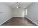 Bedroom featuring dark laminate floors, neutral colored walls, and a ceiling fan at 1013 Doby Springs Dr, Charlotte, NC 28262