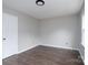 Empty bedroom featuring dark hardwood floors and a closet with two doors at 1013 Doby Springs Dr, Charlotte, NC 28262
