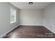 Spacious bedroom with dark wood floors and a large window providing natural light at 1013 Doby Springs Dr, Charlotte, NC 28262