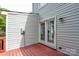 Image of the wooden deck with white siding and white trim French doors at 1013 Doby Springs Dr, Charlotte, NC 28262