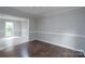 Formal dining room with dark hardwood floors, crown molding, and an adjacent room with light wood floors at 1013 Doby Springs Dr, Charlotte, NC 28262