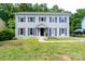 Charming two-story home with gray siding and blue shutters surrounded by a luscious green lawn at 1013 Doby Springs Dr, Charlotte, NC 28262